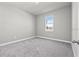 Bright bedroom with carpeted floor and large window at 44305 Timberland Ter, Punta Gorda, FL 33982