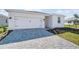 Front view of a single-story house with a two-car garage at 44305 Timberland Ter, Punta Gorda, FL 33982