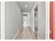 Clean hallway with light gray walls and wood-look flooring at 44305 Timberland Ter, Punta Gorda, FL 33982