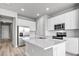 Island kitchen with stainless steel appliances and white cabinets at 44305 Timberland Ter, Punta Gorda, FL 33982