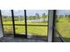 Screened porch overlooking a pond and grassy backyard at 44305 Timberland Ter, Punta Gorda, FL 33982