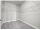 Large walk-in closet with wire shelving and gray carpeting at 44305 Timberland Ter, Punta Gorda, FL 33982