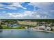 Aerial view of community with pool, tennis courts, and waterfront at 4575 Cove Cir # 304, St Petersburg, FL 33708