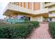 Welcoming entrance to Heritage 4575, featuring a brick pathway and lush landscaping at 4575 Cove Cir # 304, St Petersburg, FL 33708