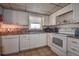 Well-equipped kitchen with white appliances and granite countertops at 4575 Cove Cir # 304, St Petersburg, FL 33708