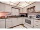 Bright kitchen with white cabinets, granite countertops, and modern appliances at 4575 Cove Cir # 304, St Petersburg, FL 33708