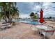 Relaxing pool area with tables, chairs, and umbrellas at 4575 Cove Cir # 304, St Petersburg, FL 33708