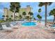Resort-style pool with ample lounge chairs and a nearby building at 4575 Cove Cir # 304, St Petersburg, FL 33708