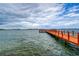 Scenic pier extending over calm waters with a sailboat in the distance at 4575 Cove Cir # 304, St Petersburg, FL 33708