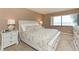 Spacious bedroom with water views and white furniture at 5633 Puerta Del Sol S Blvd # 203, St Petersburg, FL 33715