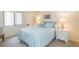 Guest bedroom with light blue bedding and white furniture at 5633 Puerta Del Sol S Blvd # 203, St Petersburg, FL 33715