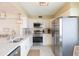 Updated kitchen with stainless steel appliances and white cabinets at 5633 Puerta Del Sol S Blvd # 203, St Petersburg, FL 33715