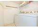 Bright laundry room, featuring washer, dryer, and ample shelving at 5633 Puerta Del Sol S Blvd # 203, St Petersburg, FL 33715