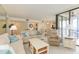 Bright living room with comfy sofas, a coffee table, and access to a balcony at 5633 Puerta Del Sol S Blvd # 203, St Petersburg, FL 33715