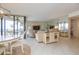 Spacious living area features a sofa, TV, and water views at 5633 Puerta Del Sol S Blvd # 203, St Petersburg, FL 33715