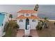 Two-story waterfront home with tile roof and attached garage at 6423 Driftwood Dr, Hudson, FL 34667