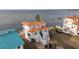 Two-story waterfront home with terracotta roof and circular driveway at 6423 Driftwood Dr, Hudson, FL 34667