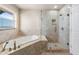 Bathroom with soaking tub and walk-in shower at 6423 Driftwood Dr, Hudson, FL 34667