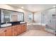 Bathroom with double vanity, soaking tub, and walk-in shower at 6423 Driftwood Dr, Hudson, FL 34667
