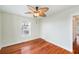 Spacious bedroom featuring hardwood floors and a ceiling fan at 6423 Driftwood Dr, Hudson, FL 34667
