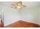 Light and airy bedroom with hardwood floors and a ceiling fan at 6423 Driftwood Dr, Hudson, FL 34667