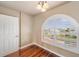 Bedroom with hardwood floors and arched window with shutters at 6423 Driftwood Dr, Hudson, FL 34667