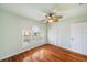Bedroom with hardwood floors, ceiling fan, and white built-in closet at 6423 Driftwood Dr, Hudson, FL 34667