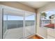 Bedroom with sliding glass doors leading to a waterfront deck at 6423 Driftwood Dr, Hudson, FL 34667