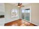 Room with hardwood floors, water view, and access to deck at 6423 Driftwood Dr, Hudson, FL 34667
