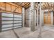 Unfinished garage, high ceilings, and an automatic garage door at 6423 Driftwood Dr, Hudson, FL 34667