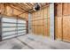 Unfinished garage with concrete flooring and an automatic garage door at 6423 Driftwood Dr, Hudson, FL 34667