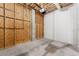 Unfinished garage with concrete flooring and some built-in shelving at 6423 Driftwood Dr, Hudson, FL 34667
