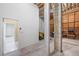 Unfinished garage with concrete floor, additional storage, and access to another room at 6423 Driftwood Dr, Hudson, FL 34667