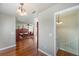 Hardwood floor hallway leading to a bedroom with a spiral staircase at 6423 Driftwood Dr, Hudson, FL 34667