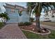 Two-story waterfront home with landscaped yard and brick driveway at 6423 Driftwood Dr, Hudson, FL 34667