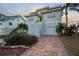 Two-story waterfront home with landscaped yard and brick driveway at 6423 Driftwood Dr, Hudson, FL 34667