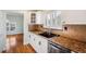 White kitchen cabinets, granite countertops and tile backsplash at 6423 Driftwood Dr, Hudson, FL 34667