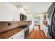 Kitchen features granite countertops, stainless steel appliances, and tiled backsplash at 6423 Driftwood Dr, Hudson, FL 34667