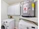 Modern laundry room with Samsung washer and dryer and cabinets at 6423 Driftwood Dr, Hudson, FL 34667