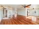 Open living space with hardwood floors, spiral staircase, and kitchen peek at 6423 Driftwood Dr, Hudson, FL 34667