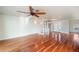 Spacious living area featuring hardwood floors and a spiral staircase at 6423 Driftwood Dr, Hudson, FL 34667