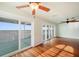 Bright living room with hardwood floors and sliding glass doors leading to a deck with water views at 6423 Driftwood Dr, Hudson, FL 34667