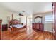 Main bedroom with hardwood floors, a king-size bed, and water views at 6423 Driftwood Dr, Hudson, FL 34667