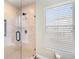 Large walk-in shower with beige tile and glass enclosure at 6423 Driftwood Dr, Hudson, FL 34667