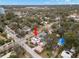 Aerial view of a pink house with solar panels in a residential neighborhood at 700 S Prospect Ave, Clearwater, FL 33756