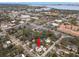 Aerial view showcasing a pink house with solar panels in a residential neighborhood near the water at 700 S Prospect Ave, Clearwater, FL 33756
