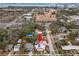 Aerial view of a charming pink house with solar panels, located in a residential neighborhood at 700 S Prospect Ave, Clearwater, FL 33756
