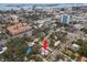 Aerial view showing a pink house with solar panels in a quiet residential neighborhood at 700 S Prospect Ave, Clearwater, FL 33756
