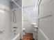 Clean bathroom with white tiled walls and wood floor at 700 S Prospect Ave, Clearwater, FL 33756