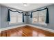 Spacious bedroom with hardwood floors and blue walls at 700 S Prospect Ave, Clearwater, FL 33756